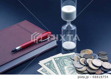 Hourglass, money, pen and notebook are on the Hourglass, money, pen and notebook are on the 68819754