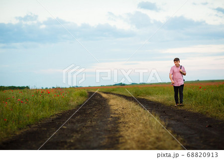 man goes in dirty dirt road after rain man goes in dirty dirt road after rain 68820913