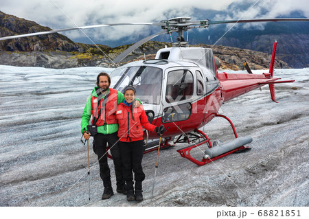 Alaska helicopter tour tourist couple on cruise excursion glacier hike activity in Skagway, Alaska, USA travel. Tourists portrait on helicopter ride in mountains landscape on summer vacation. Alaska helicopter tour tourist couple on cruise excursion glacier hike activity in Skagway, Alaska, USA travel. Tourists portrait on helicopter ride in mountains landscape on summer vacation. 68821851