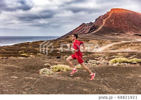 Athlete health and fitness trail runner man running in desert outdoor wearing compression clothes. Sport endurance training man for race. 68821921