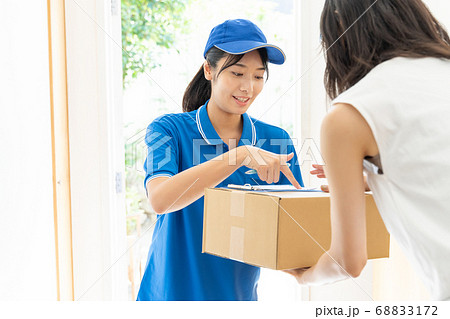荷物を届ける宅配便の女性ドライバー 68833172