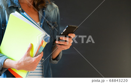 student with books and smartphone student with books and smartphone 68843220