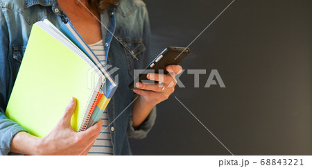 student with books and smartphone student with books and smartphone 68843221