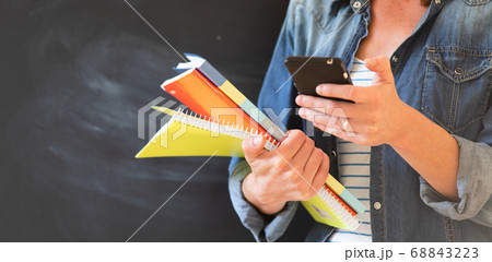 student with books and smartphone 68843223