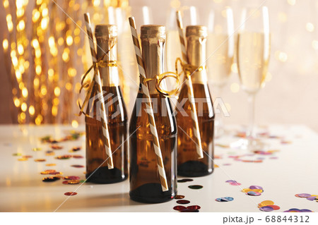 Champagne glasses and mini bottles on decorated Champagne glasses and mini bottles on decorated 68844312
