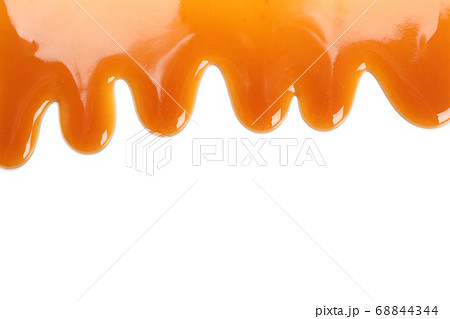 Flowing caramel sauce isolated on white 68844344