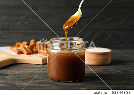 Glass jar with salted caramel and candies on 68844358