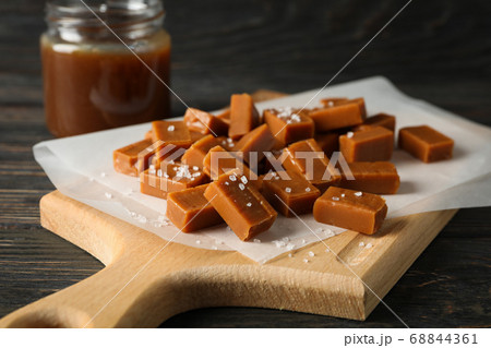 Glass jar with salted caramel and candies on 68844361