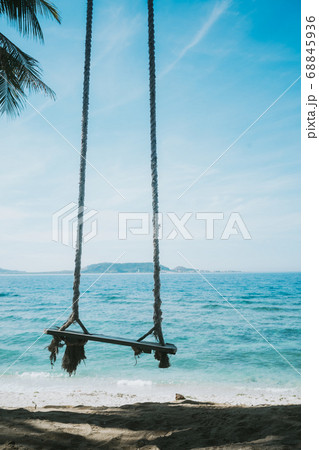 a lonely swing on the beach 68845936
