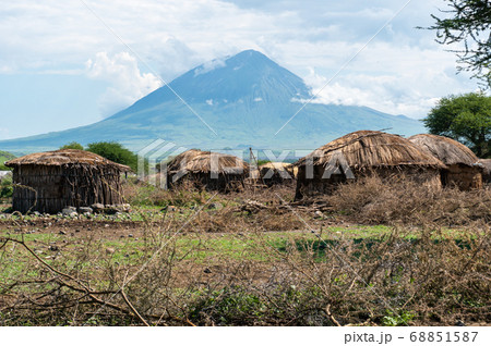 Traditional Maasai Village with Clay Round Huts in Engare Sero area near Lake Natron and Ol Doinyo Lengai volcano in Tanzania, Africa 68851587