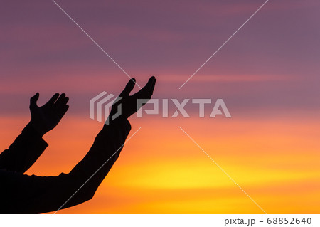 Silhouette of woman hands holding over beautiful 68852640