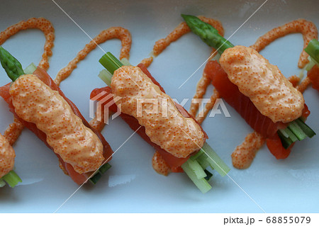 Salmon fillet wrap on asparagus vegetables and pour with the eggs of fish 68855079