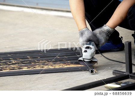 Worker use hand grinder . Worker use hand grinder . 68856639