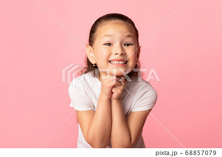 Hopeful little asian girl praying for something 68857079
