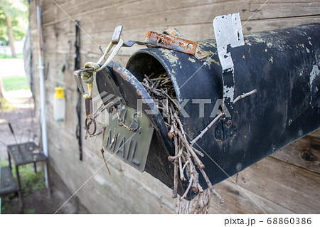 Old Abandoned country mail box with bird nest inside it  68860386