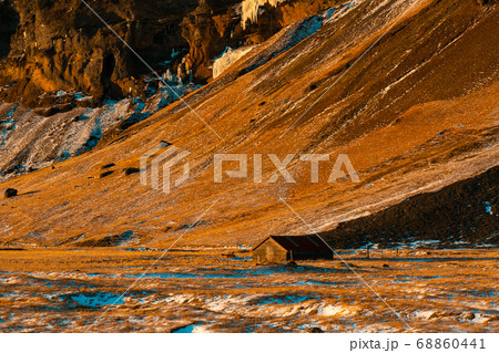 A lonely house at the foot of the mountains in 68860441