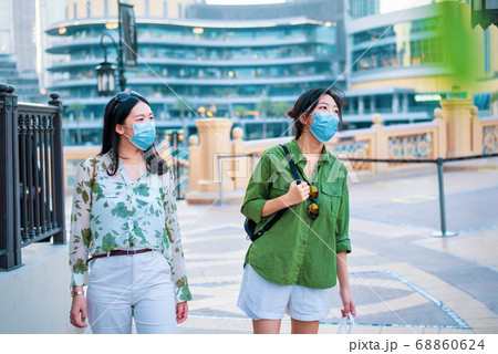 Two female friends Asian woman wearing face mask 68860624
