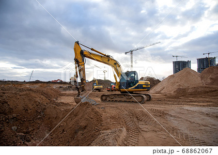 Excavator during earthmoving at construction site. 68862067