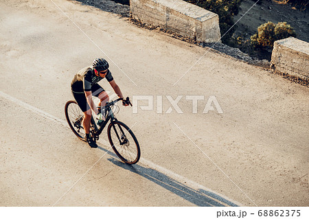 Professional cyclist on a mountain road at sunrise 68862375