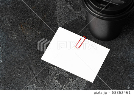 White businesscards united with a paper clip on a black rough background White businesscards united with a paper clip on a black rough background 68862461