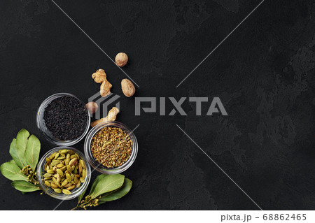Bowls with assorted spices on dark background 68862465
