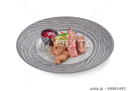 Grilled beef steak on grey plate isolated on white Grilled beef steak on grey plate isolated on white 68863465