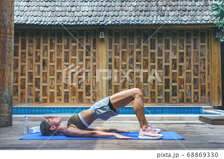 Young fit woman doing yoga stretching exercise Young fit woman doing yoga stretching exercise 68869330