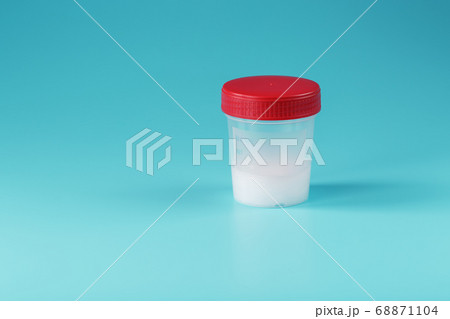 Semen in a test container with a red lid on a Semen in a test container with a red lid on a 68871104