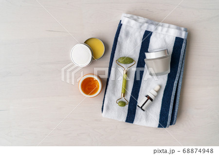 Natural skincare products - organic diy mud mask facial treatment Luxury spa bathroom women beauty creams and balm with jade face roller on towel. Top view background 68874948