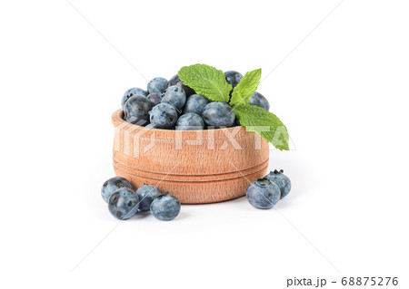 Wooden bowl with blueberries isolated on white Wooden bowl with blueberries isolated on white 68875276