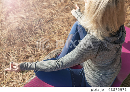 Girl in sportswear in yoga lotus position  68876971