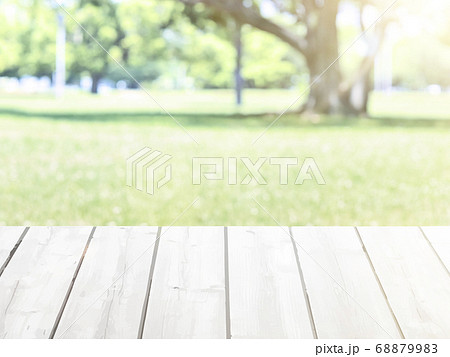 Wooden table on blurred nature green background 68879983