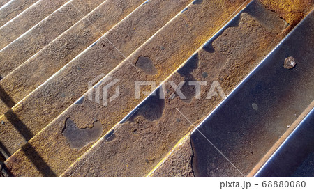 Textured rusty metal staircase with yellow shades Textured rusty metal staircase with yellow shades 68880080