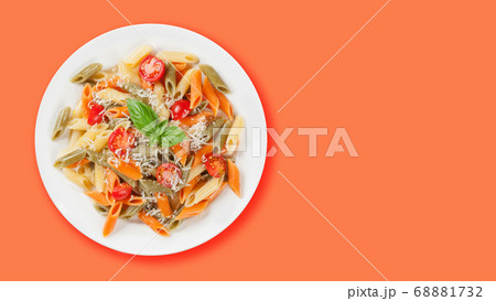 Colorful penne pasta with tomatoes and basil Colorful penne pasta with tomatoes and basil 68881732