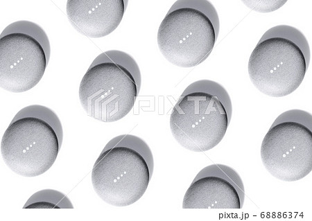 Flat lay of smart speaker with LED lights activated and smartphone isolated on white background. 68886374