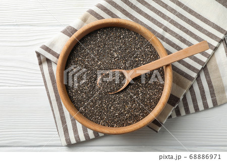Wooden bowl with chia and spoon on white wooden 68886971