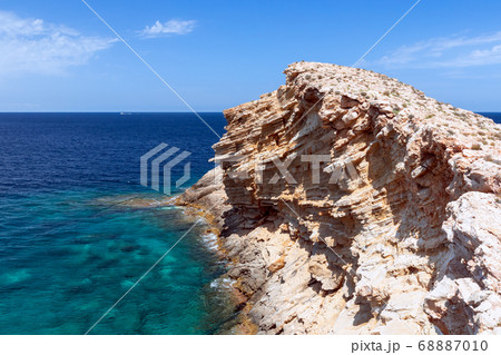 Cape Punta Galera. Ibiza, Balearic Islands, Spain. A wave frozen in stone in the emerald sea. 68887010