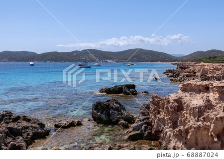 View of the beautiful rocky coast turquoise sea with boats. Ibiza. Balearic Islands, Spain View of the beautiful rocky coast turquoise sea with boats. Ibiza. Balearic Islands, Spain 68887024