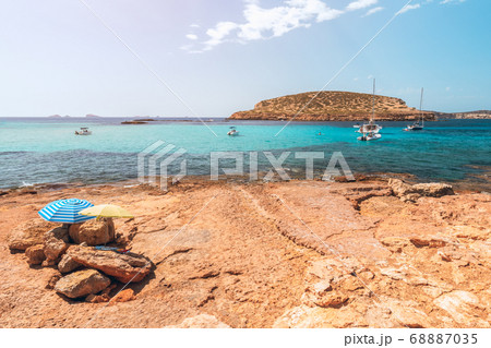 Secluded little rocky beach on the Ibiza island. Balearic Islands, Spain (Vintage photo effect) Secluded little rocky beach on the Ibiza island. Balearic Islands, Spain (Vintage photo effect) 68887035