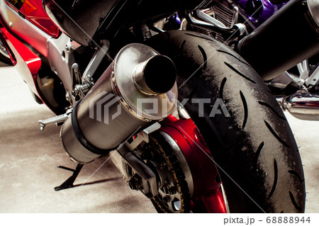 Back exhaust pipe of sportbike close-up in garage Back exhaust pipe of sportbike close-up in garage 68888944