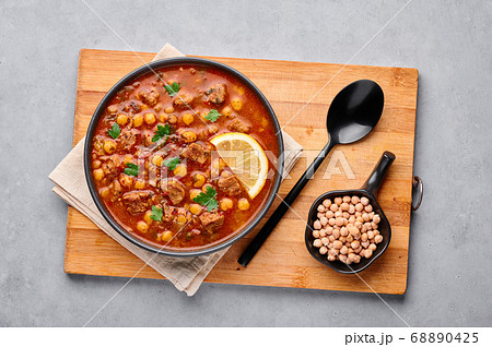 Moroccan Harira Soup in black bowl at grey table top Moroccan Harira Soup in black bowl at grey table top 68890425