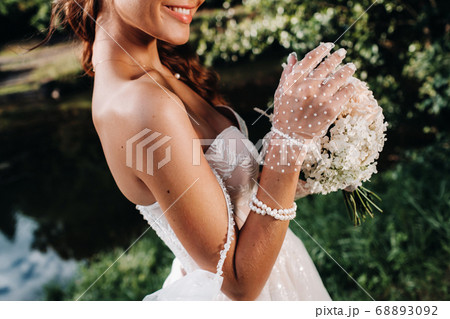 portrait of an elegant bride in a white dress with 68893092
