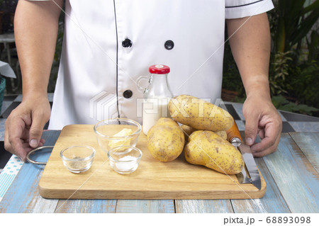 Chef and Ingredients to make mashed Potatoes 68893098