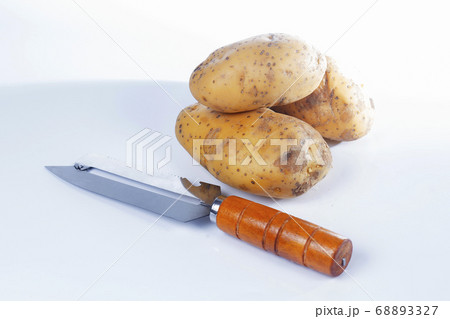 Paring knife wooden handle and potato 68893327