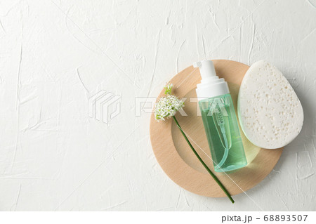 Lotion, allium flower and sponge on white Lotion, allium flower and sponge on white 68893507