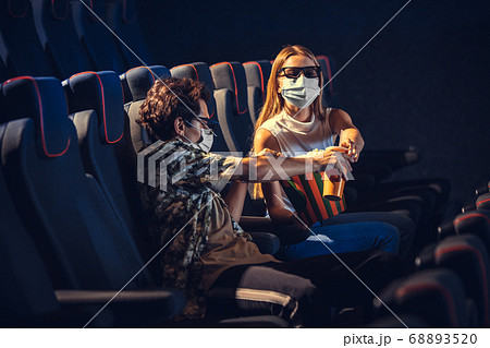 Cinema, movie theatre during quarantine. Coronavirus pandemic safety rules, social distance during movie watching 68893520