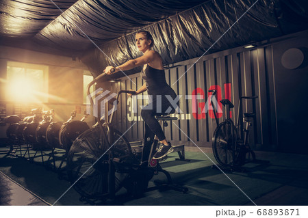 The female athlete training hard in the gym. Fitness and healthy life concept. 68893871