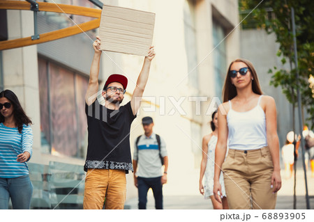 Dude with sign - man stands protesting things that annoy him 68893905