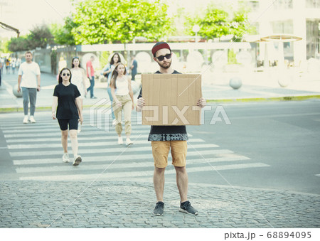 Dude with sign - man stands protesting things that annoy him 68894095