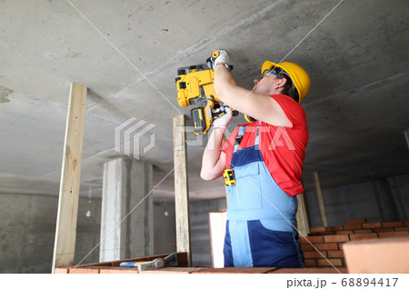 Builder works with special equipment on ceiling Builder works with special equipment on ceiling 68894417
